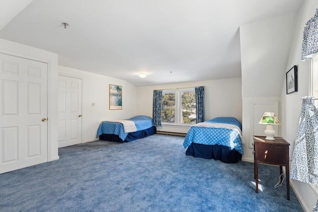 carpeted bedroom featuring a baseboard heating unit