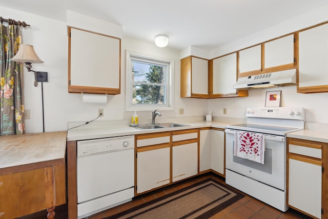 kitchen with sink, white appliances, and white cabinets