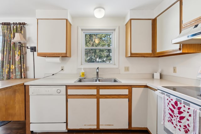 kitchen with white appliances, sink, and white cabinets