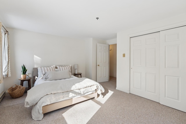 bedroom with light carpet and a closet