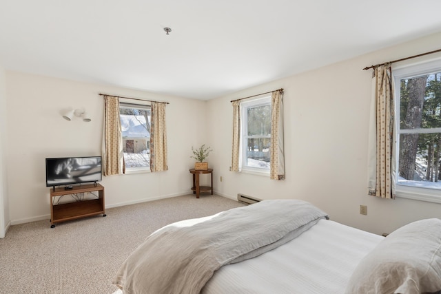 bedroom with light colored carpet and a baseboard radiator