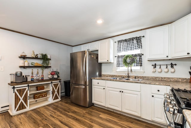 kitchen with a sink, appliances with stainless steel finishes, white cabinets, and dark wood-style flooring