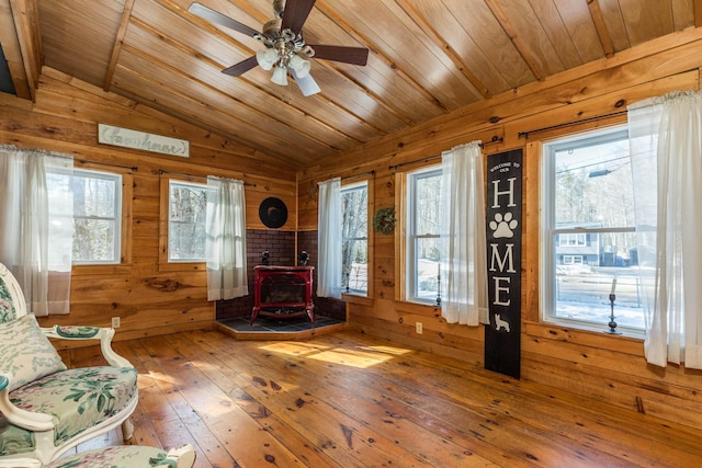 entryway with wooden walls and lofted ceiling