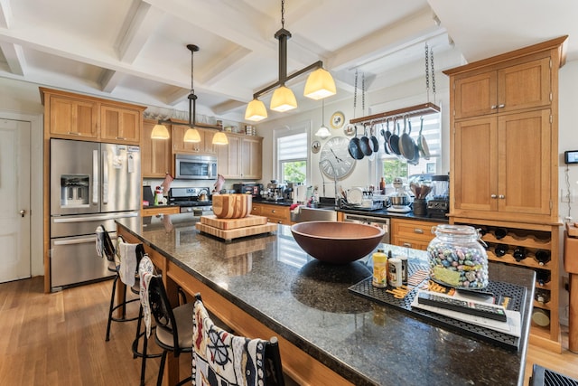 823 Washington St, Bath, ME 04530 - kitchen with coffered ceiling, a breakfast bar area, hanging light fixtures, light wood-type flooring, and appliances with stainless steel finishes