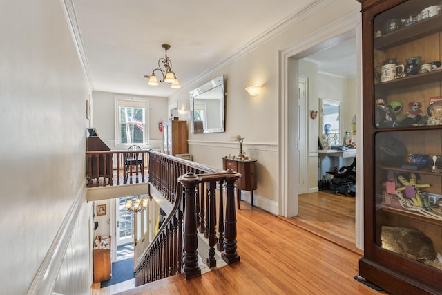 823 Washington St, Bath, ME 04530 - hallway with hardwood / wood-style floors, crown molding, and a chandelier