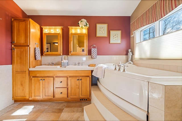 bathroom featuring a tub, tile patterned floors, a sink, and double vanity