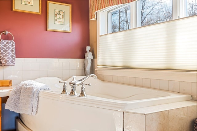 full bath with a healthy amount of sunlight and a garden tub