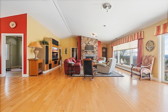 living area with vaulted ceiling, a fireplace, light wood-style flooring, and baseboards