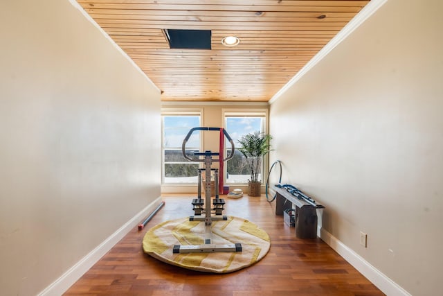 exercise area featuring ornamental molding, wood finished floors, wood ceiling, and baseboards