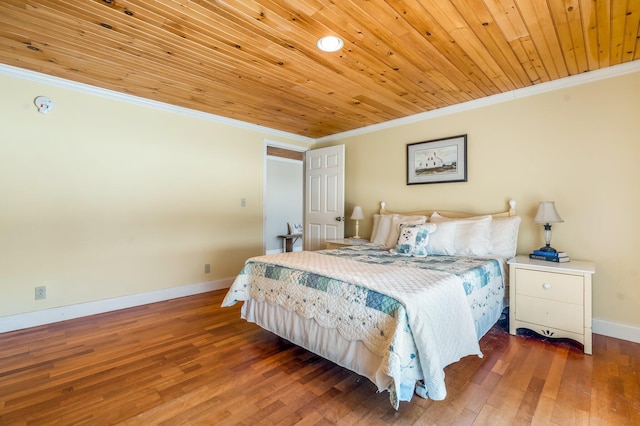 bedroom featuring ornamental molding, wooden ceiling, wood finished floors, and baseboards