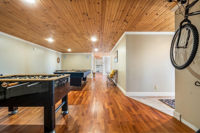 rec room featuring crown molding, wooden ceiling, wood finished floors, and baseboards