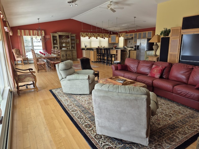 528 W Rd, Belgrade, ME 04917 - living room featuring lofted ceiling, light wood-style floors, ceiling fan, a chandelier, and a baseboard radiator