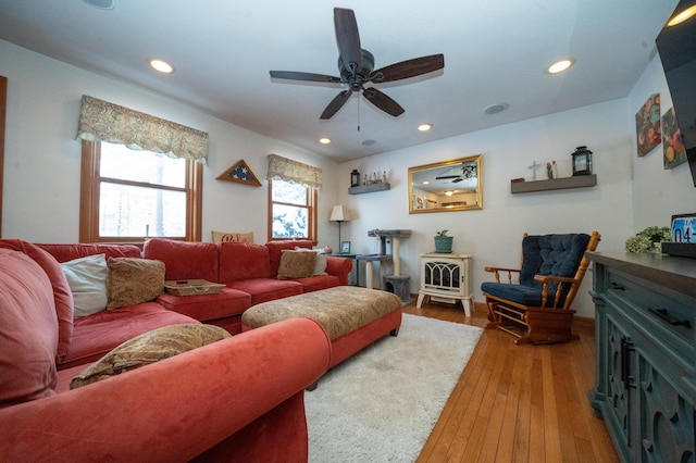 living room featuring ceiling fan and hardwood / wood-style floors