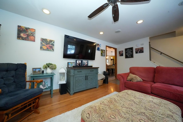 living room featuring ceiling fan and light hardwood / wood-style floors