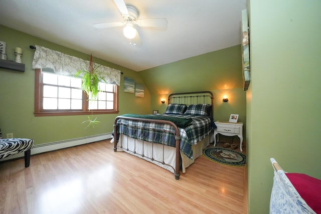 bedroom featuring ceiling fan, light wood-type flooring, vaulted ceiling, and baseboard heating