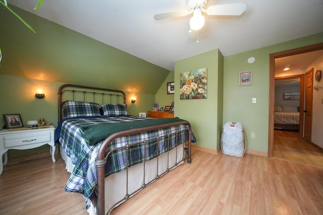 bedroom with vaulted ceiling, ceiling fan, and light hardwood / wood-style floors