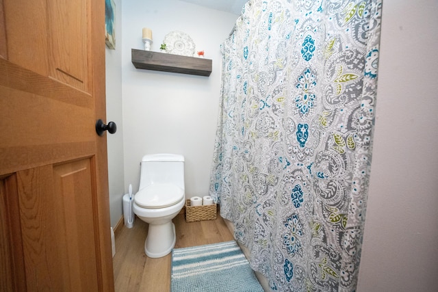 bathroom with wood-type flooring and toilet