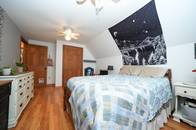 bedroom with ceiling fan, lofted ceiling, and light hardwood / wood-style flooring