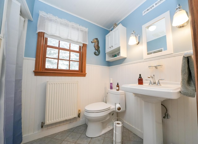 bathroom with sink, radiator heating unit, tile patterned floors, and toilet