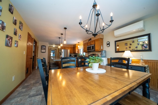 dining area featuring a chandelier and an AC wall unit