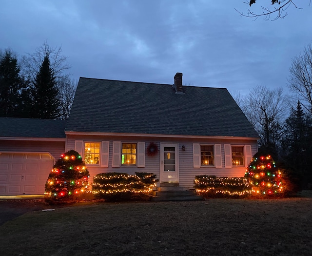 view of front of property featuring a garage and a lawn