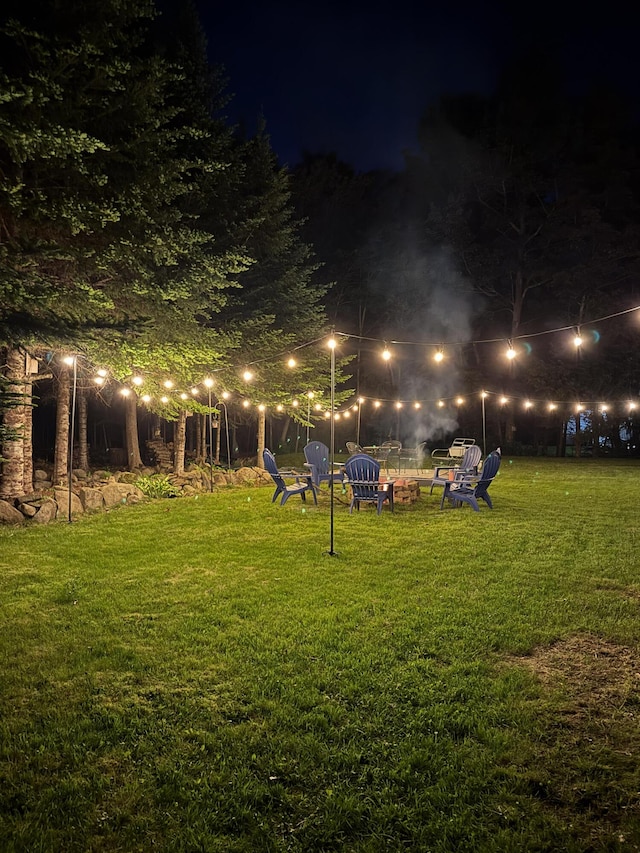 yard at twilight featuring a fire pit