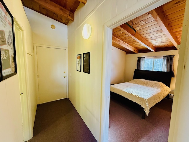 carpeted bedroom featuring vaulted ceiling with beams and wooden ceiling