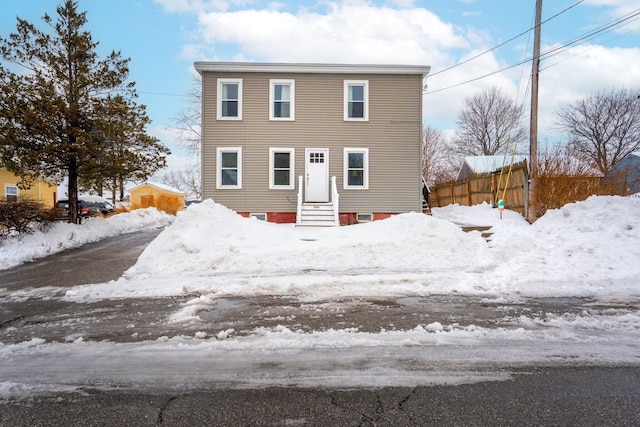 view of front of house featuring entry steps and fence