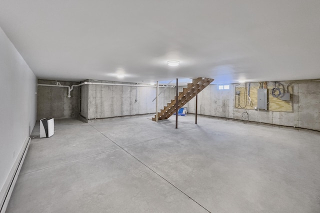 basement featuring electric panel and a baseboard heating unit