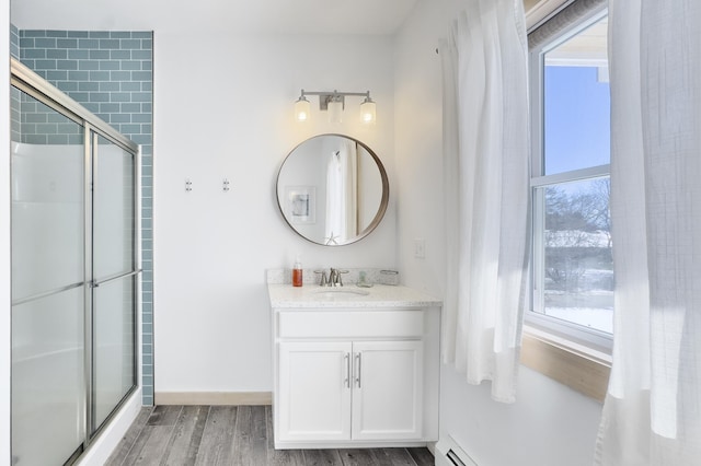 bathroom featuring hardwood / wood-style flooring, vanity, and an enclosed shower