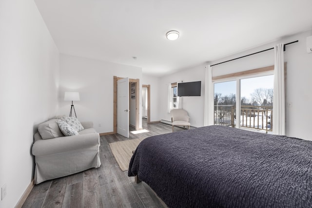 bedroom with hardwood / wood-style floors and access to outside