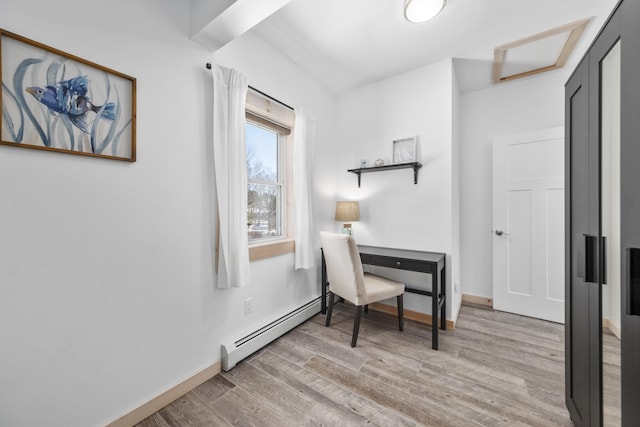home office featuring a baseboard radiator and light wood-type flooring