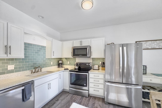 kitchen featuring tasteful backsplash, sink, stainless steel appliances, and white cabinets