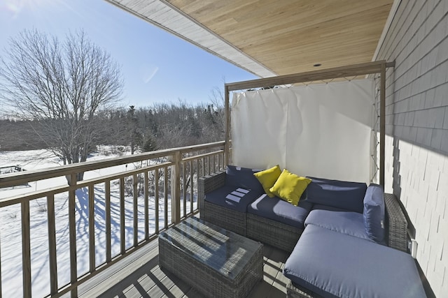view of snow covered back of property