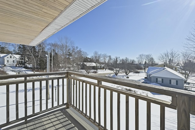 view of snow covered back of property