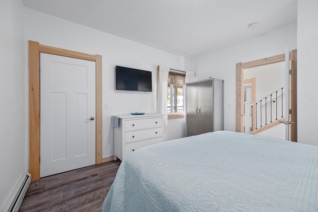 bedroom featuring a baseboard radiator and dark wood-type flooring