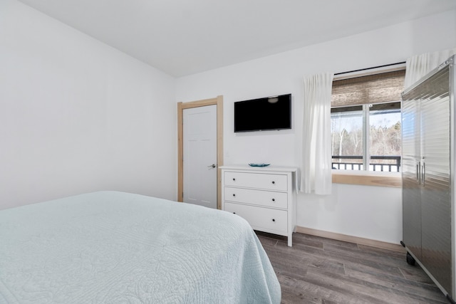 bedroom with dark wood-type flooring