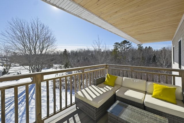 view of snow covered back of property
