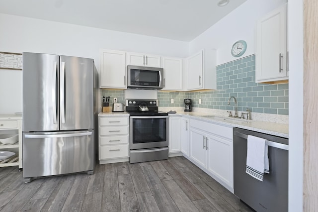 kitchen with white cabinetry, appliances with stainless steel finishes, sink, and dark wood-type flooring