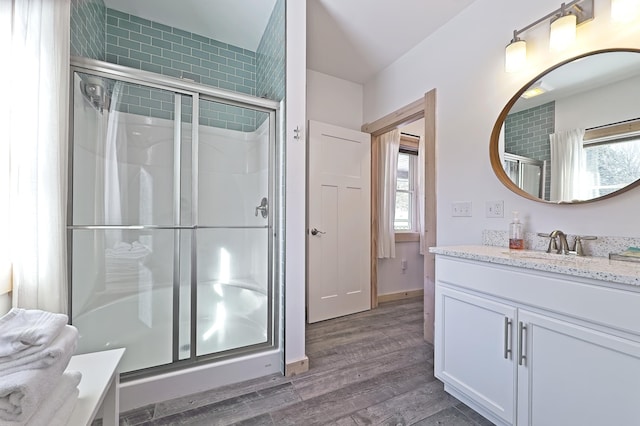 bathroom with vanity, hardwood / wood-style floors, and walk in shower