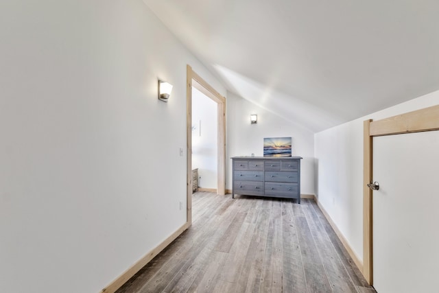 bonus room featuring vaulted ceiling and light hardwood / wood-style floors