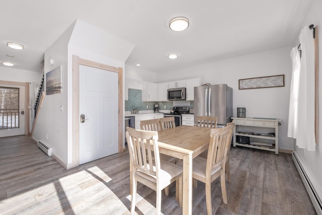 dining area featuring light hardwood / wood-style floors and a baseboard heating unit