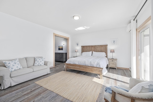 bedroom featuring hardwood / wood-style flooring and baseboard heating