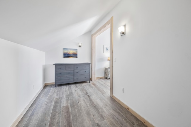 interior space with vaulted ceiling and light hardwood / wood-style floors