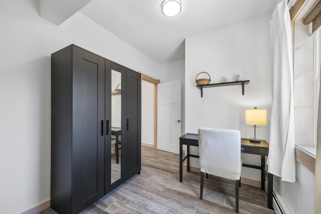 office area featuring a baseboard radiator and hardwood / wood-style floors