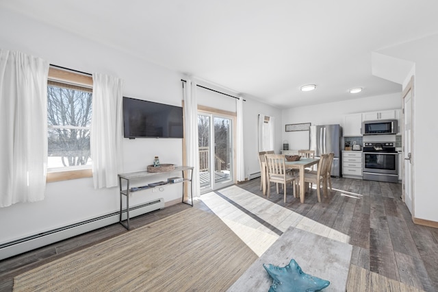 living room featuring baseboard heating and dark hardwood / wood-style floors