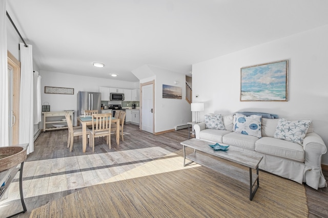 living room with dark hardwood / wood-style floors and a baseboard heating unit