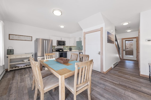 dining area with wood-type flooring, a baseboard heating unit, and sink