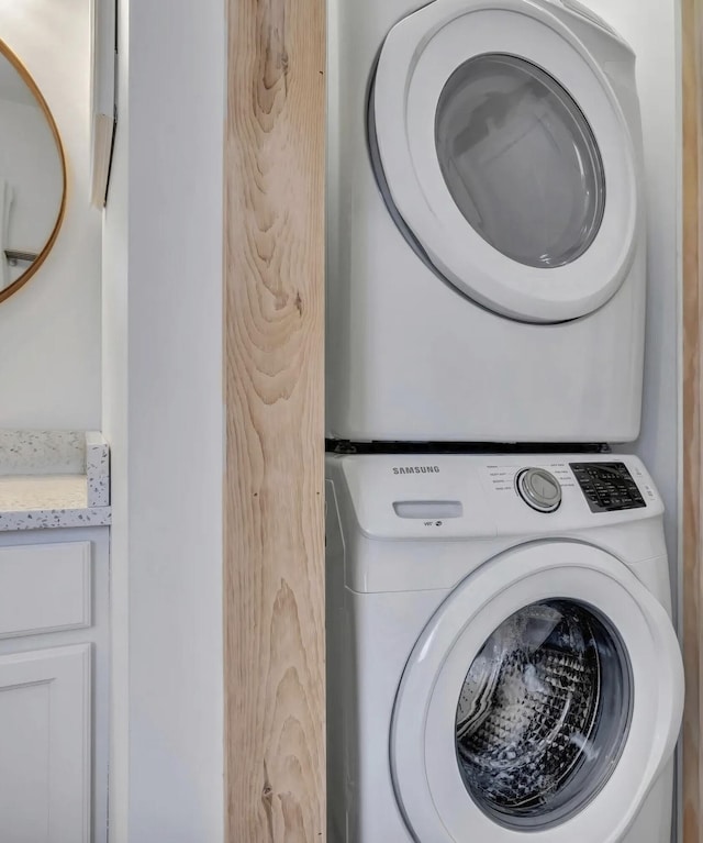 laundry room with stacked washing maching and dryer