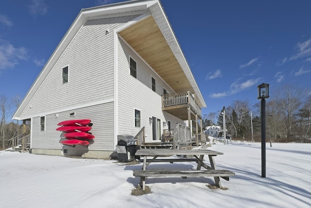 view of snow covered exterior featuring a balcony